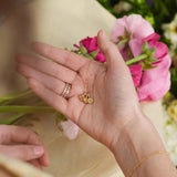 A collection of birthstone rings, birthstone hoop earnings, and birthstone stud earrings.