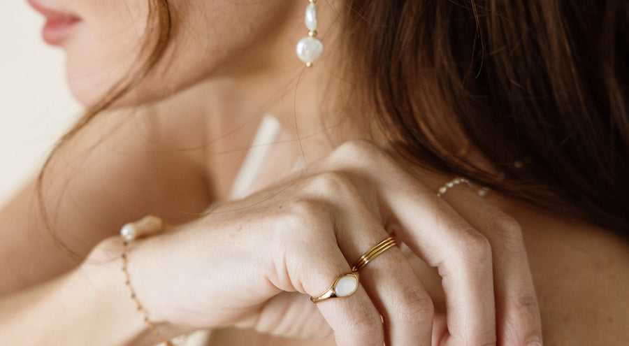 Gold vermeil chain necklace coupled with stacking dainty rings and custom gold rings