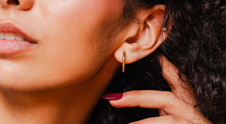 model wearing 14k solid gold hoop earring and ring
