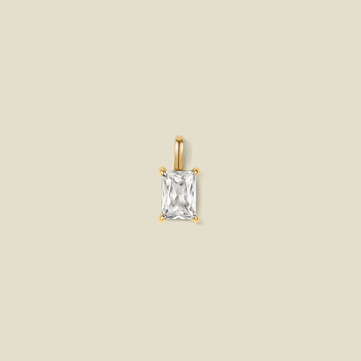 A pendant charm featuring a clear baguette-cut prong set gemstone.