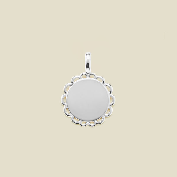 Silver round disc charm with scalloped edge detail