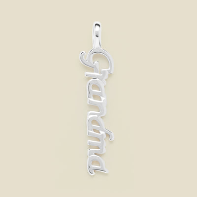 Silver "Grandma" charm on a beige background