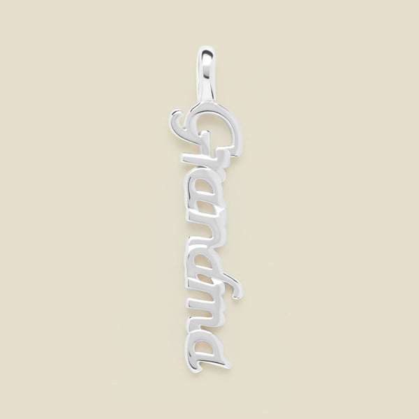 Silver "Grandma" charm on a beige background