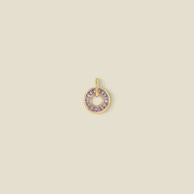 A circular pendant featuring light purple baguette-cut stones around a hollow center, displayed against a solid light beige background.