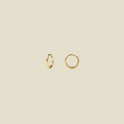 Gold hoops against a neutral background.