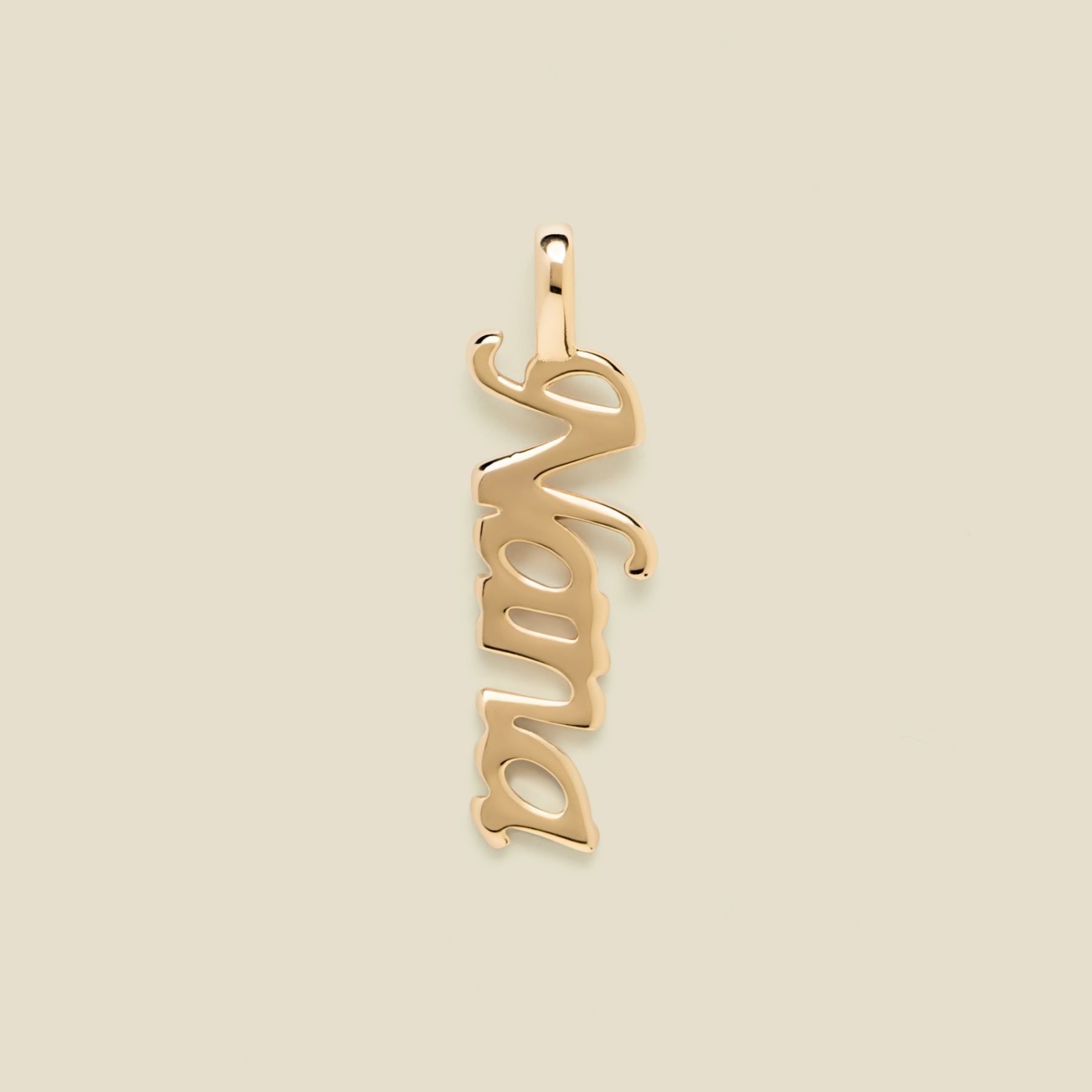 Gold "Nana" charm on a beige background