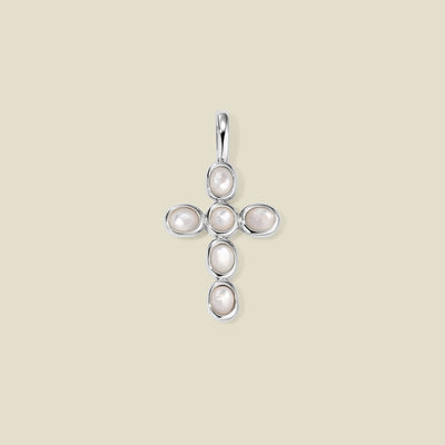 Silver cross pendant made of bezel-set pearl stones, suspended against a neutral background.