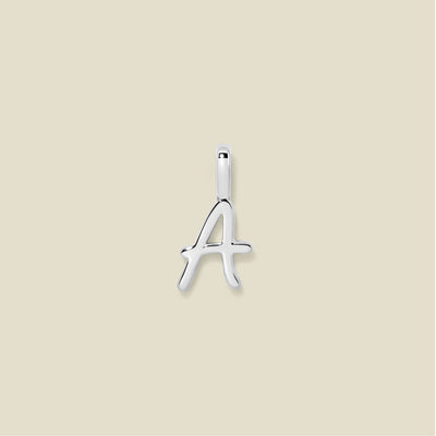 Silver letter 'A' pendant on a beige background