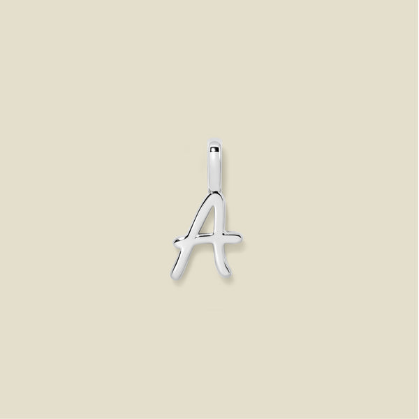Silver letter 'A' pendant on a beige background