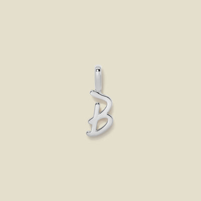 Silver "B" Initial Charm on a beige background