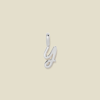 A silver charm letter Y against a neutral background.