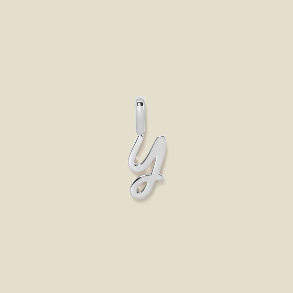 A silver charm letter Y against a neutral background.