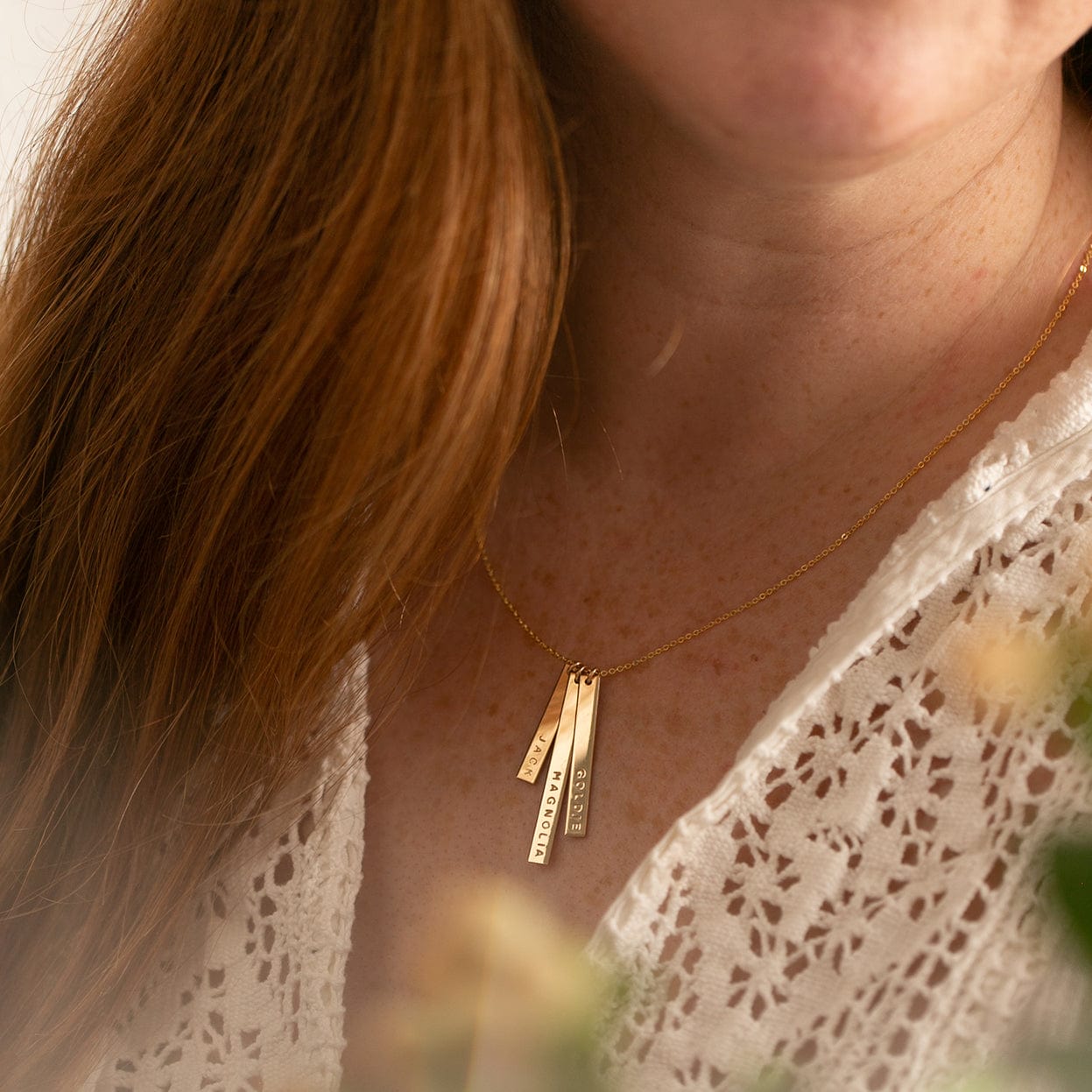 Vertical gold store bar necklace